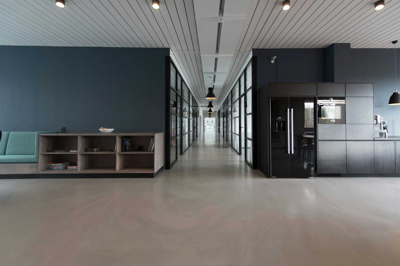 Open glass office interior with long desks and city light